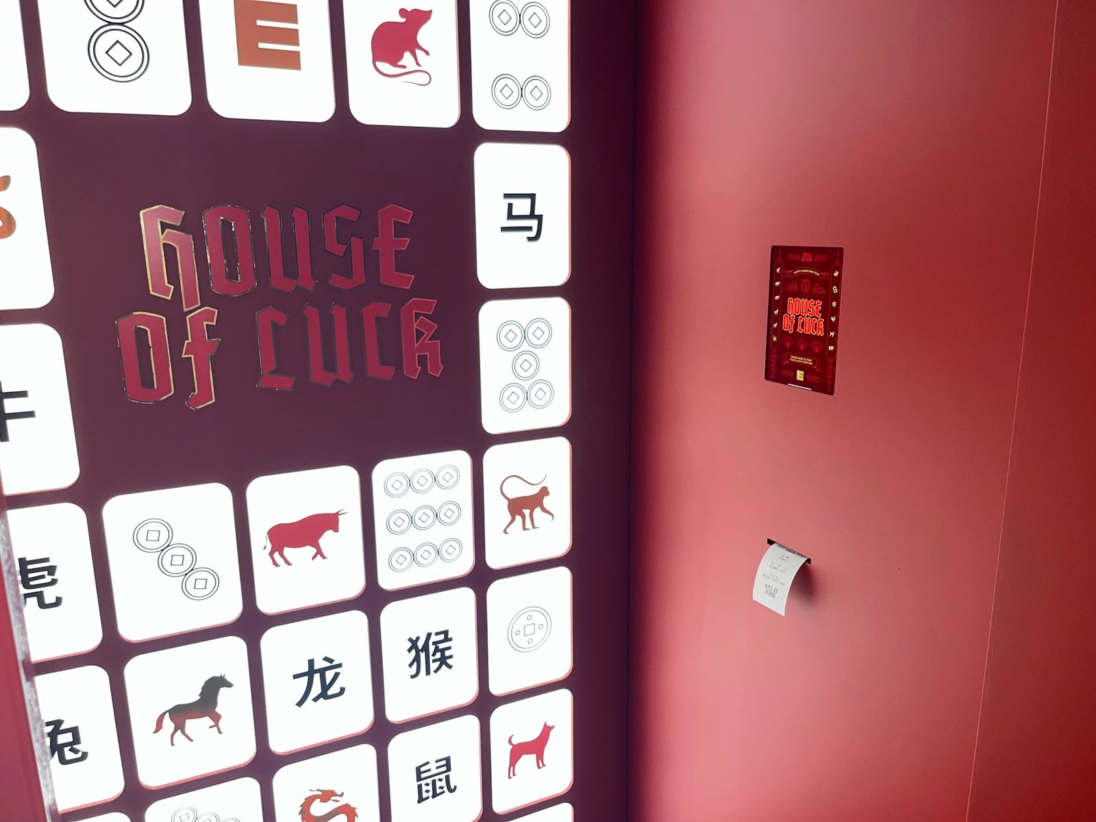 House of Luck — interactive Lunar New Year fortune-telling installation at Emporium Melbourne, with a printed fortune ticket beside the screen.