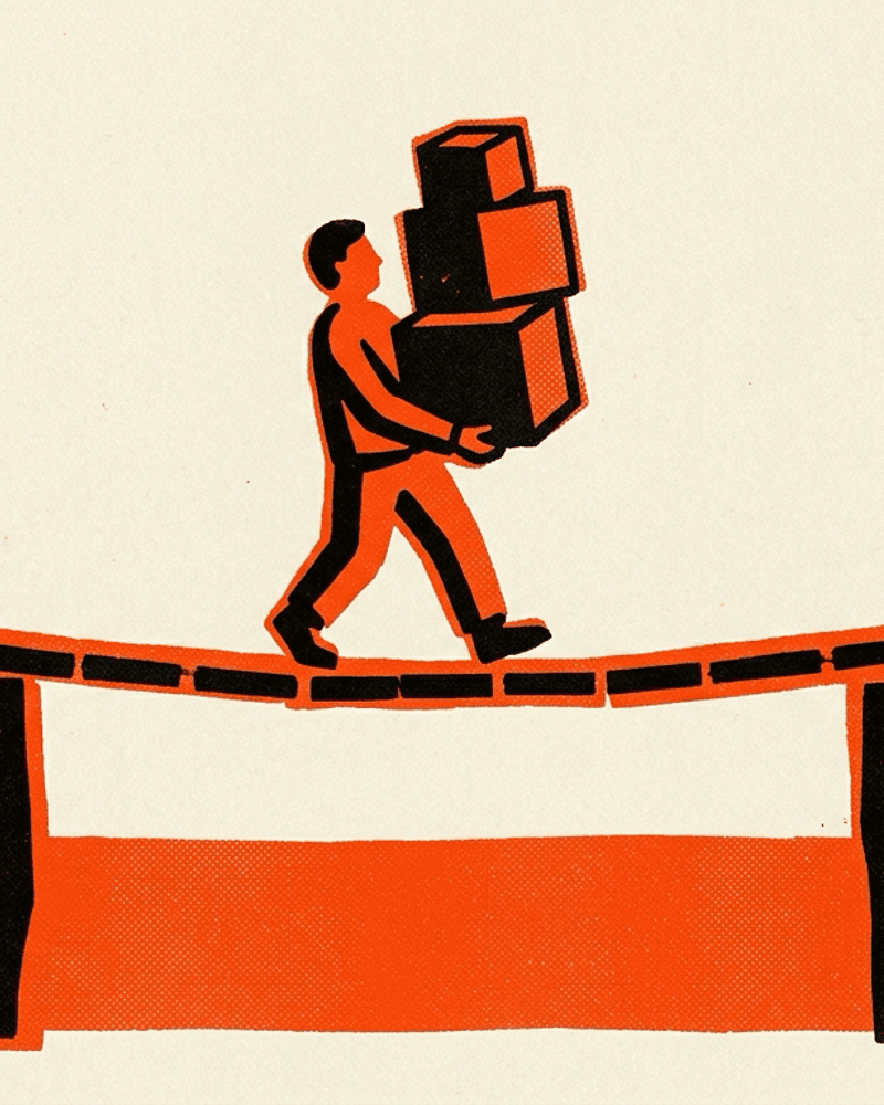 A figure carrying a stack of boxes across a narrow plank bridge from a small tent to a solid building